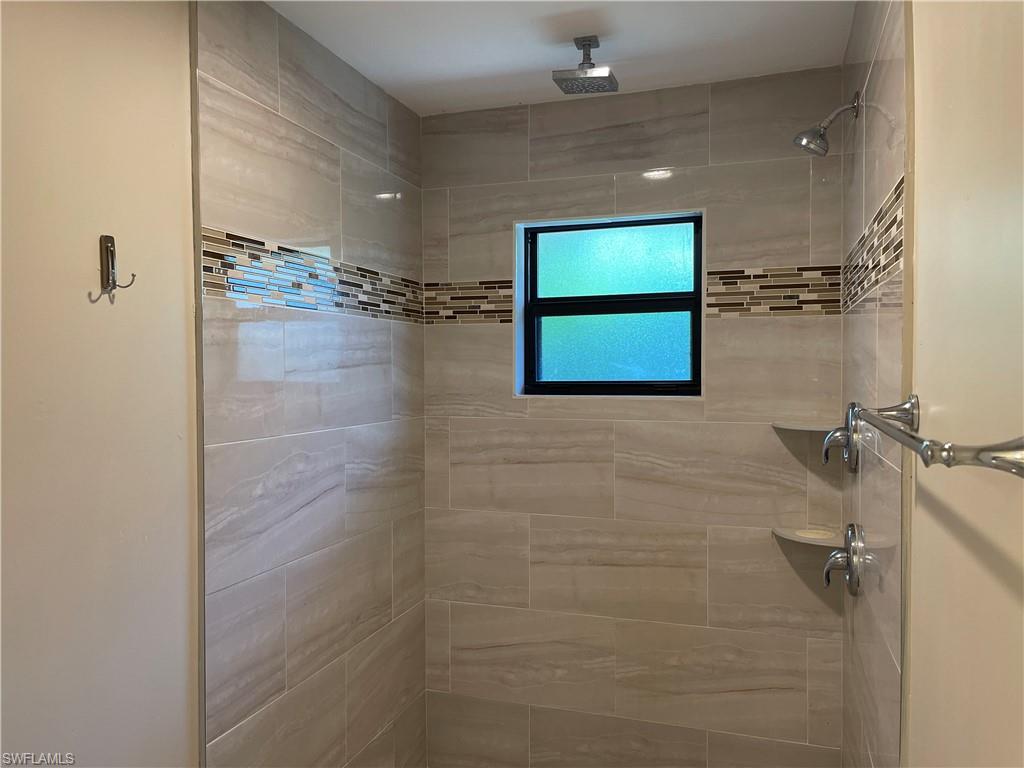 255 Pine Valley Circle Naples, FL 34113 - Photo 14 of 27 a bathroom with a shower and a mirror