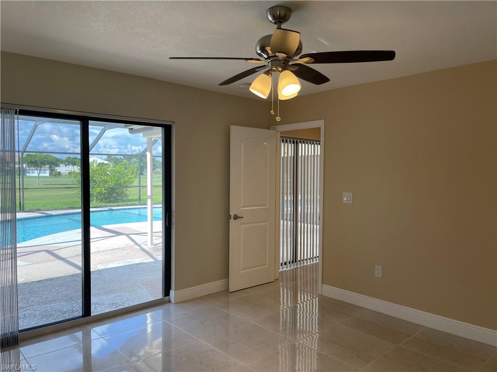 255 Pine Valley Circle Naples, FL 34113 - Photo 15 of 27 a view of an empty room with a window
