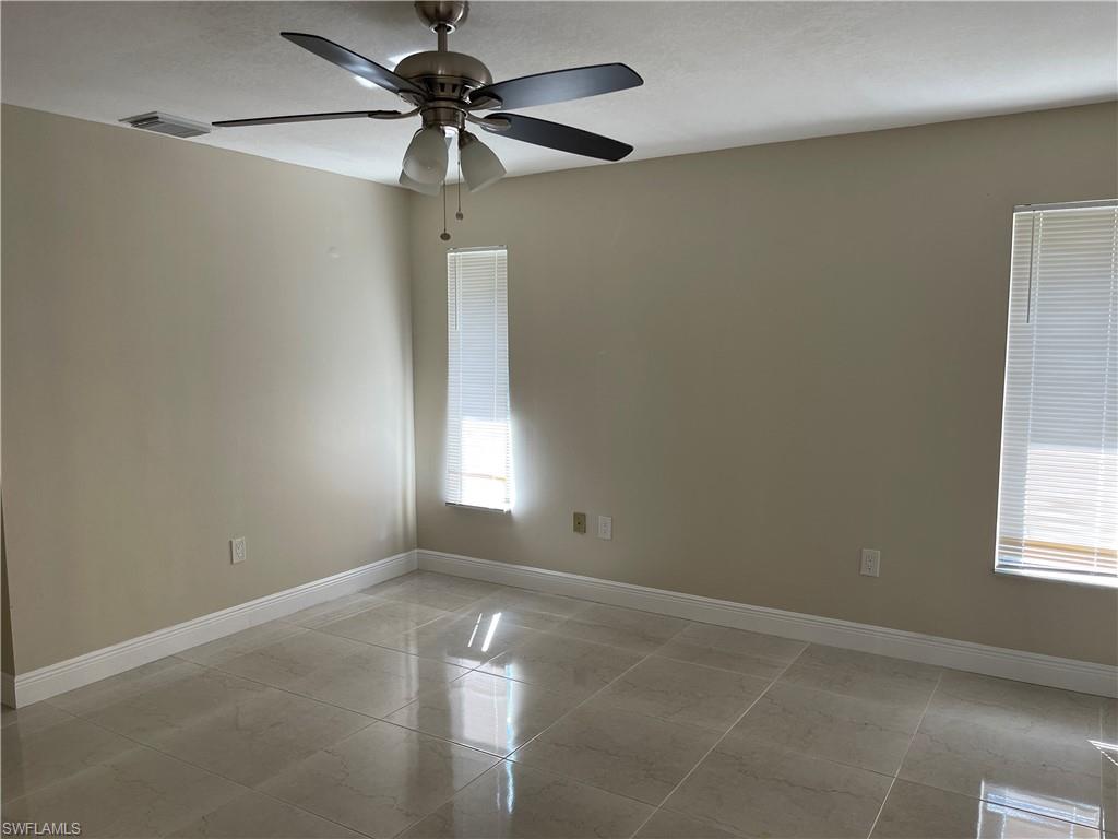 255 Pine Valley Circle Naples, FL 34113 - Photo 26 of 27 a view of an empty room with a window
