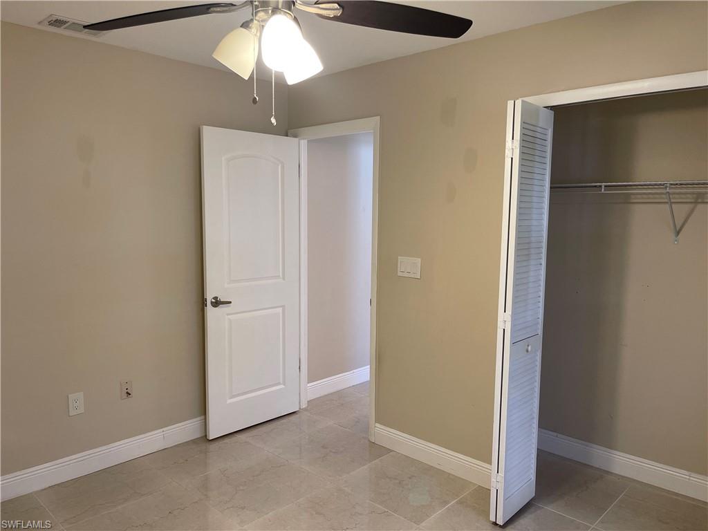 255 Pine Valley Circle Naples, FL 34113 - Photo 27 of 27 a view of an empty room with a ceiling fan