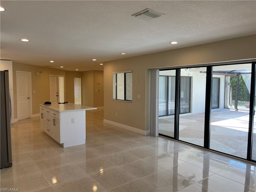 255 Pine Valley Circle Naples, FL 34113 - Photo 4 of 27 a view of an empty room with kitchen view and a window