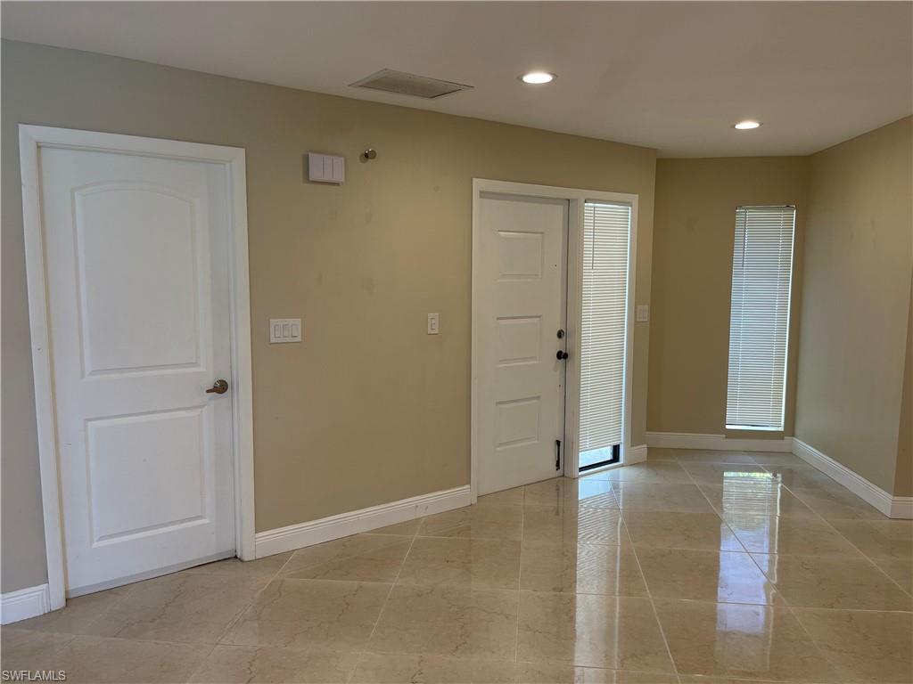 255 Pine Valley Circle Naples, FL 34113 - Photo 10 of 27 an empty room with wooden door
