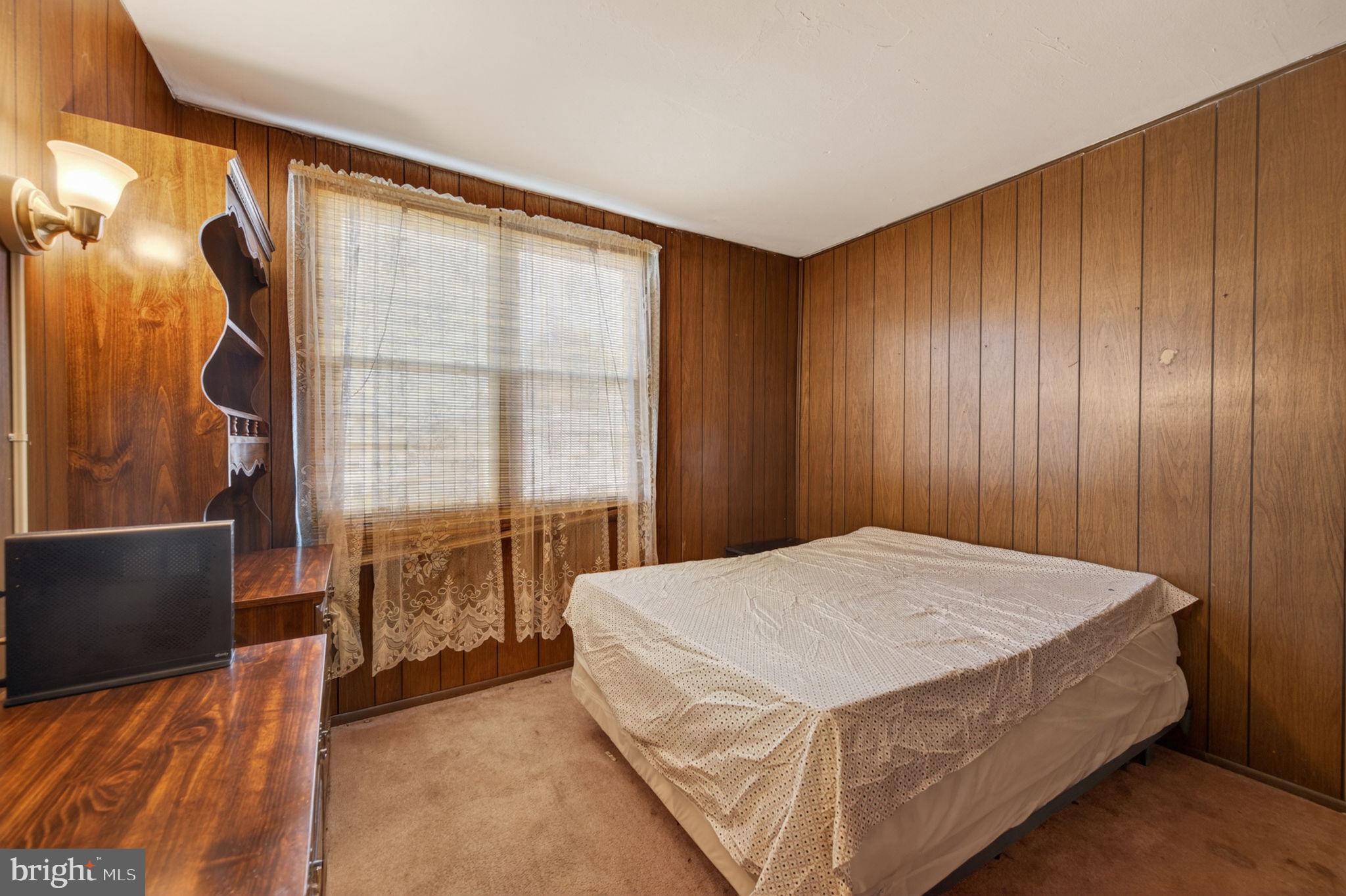 952 Armistead Way Baltimore, MD 21205 - Photo 9 of 13 a bed sitting in a spacious bedroom next to a window