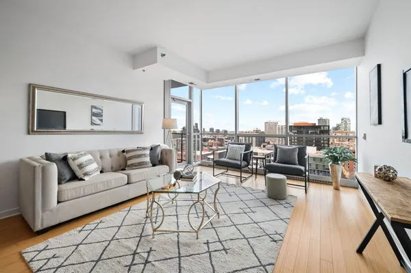 a living room with furniture and a floor to ceiling window