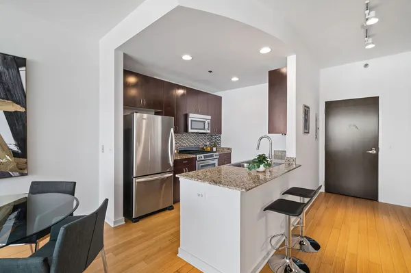 a kitchen with kitchen island a refrigerator stove and microwave