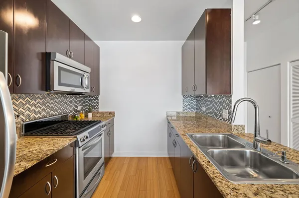 a kitchen that has a sink and a stove