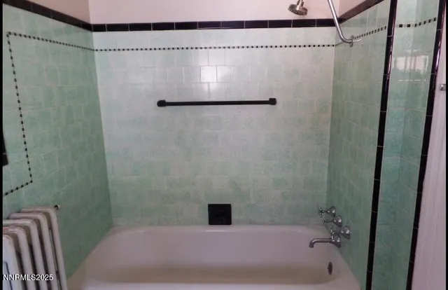 a bathroom with a shower and a tub