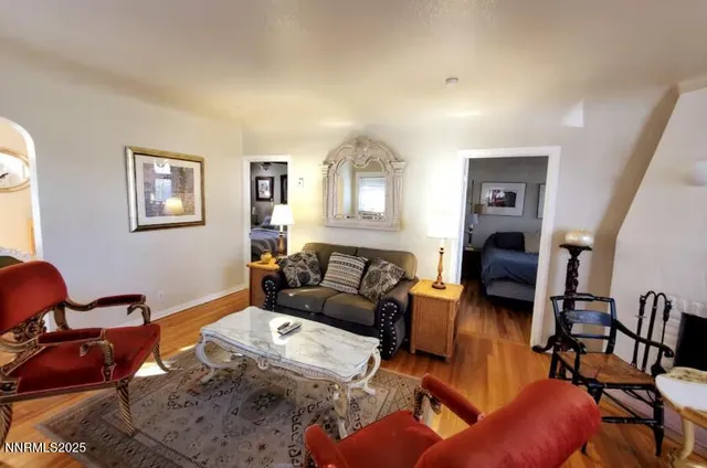 a living room with furniture a couch and paintings on the wall