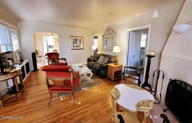 a living room with furniture a couch and wooden floor