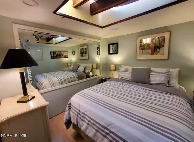 a bedroom with two beds and painting on the wall