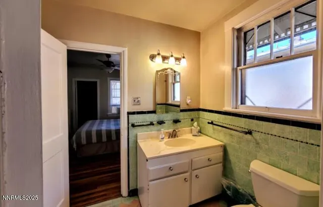 a bathroom with a toilet sink and mirror