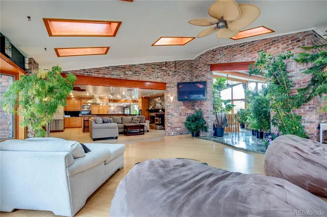 a living room with patio furniture and a fireplace