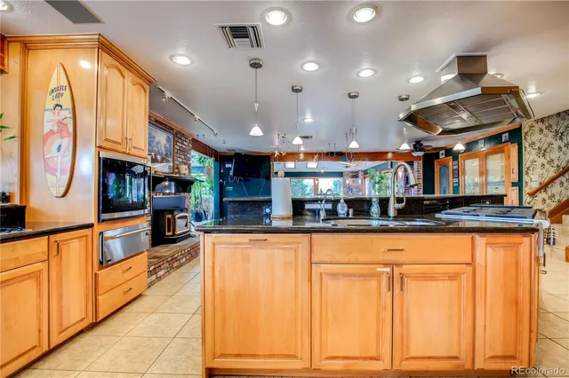 a kitchen with stainless steel appliances granite countertop a sink and cabinets