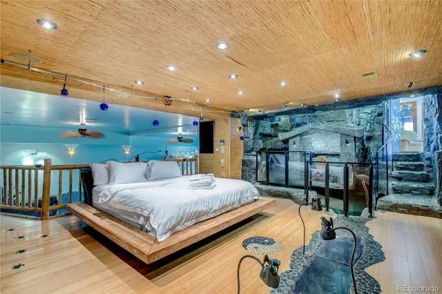 a bedroom with a bed a table and chairs