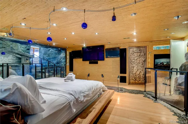 a bedroom with a bed and a flat screen tv