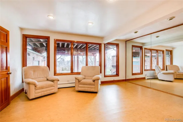 a living room with furniture and large windows