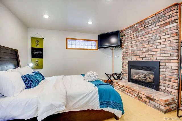 a bedroom with a bed and a fireplace