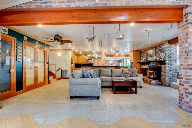 a living room with furniture a fireplace and a walk in closet