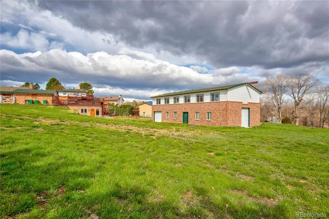 a view of a big yard with large trees