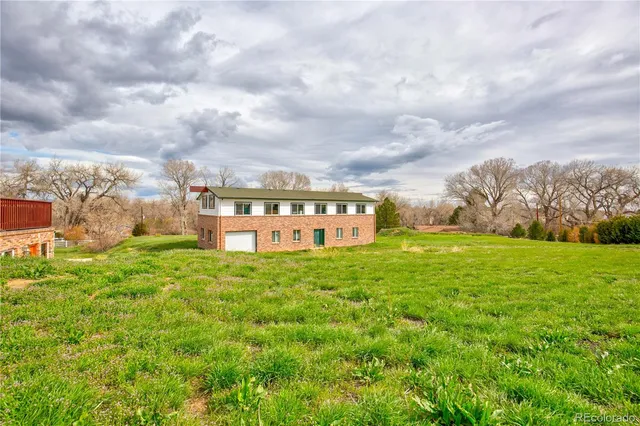 a view of a big yard with large trees