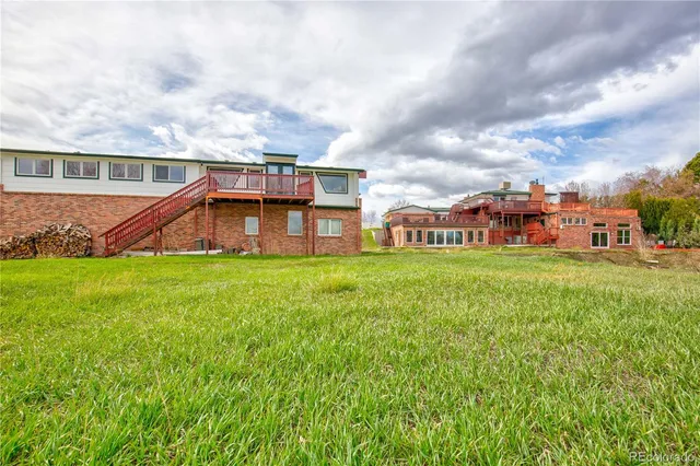 a view of a house with a yard and sitting area
