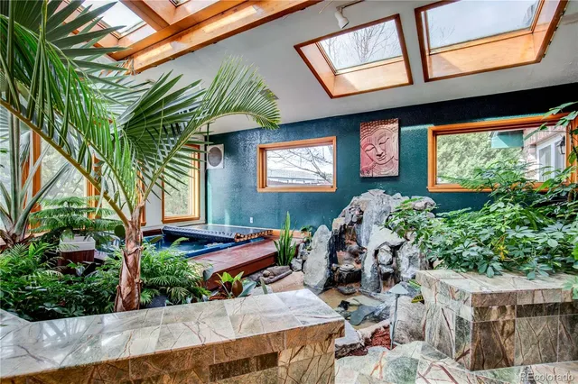 a front view of a house with porch and furniture