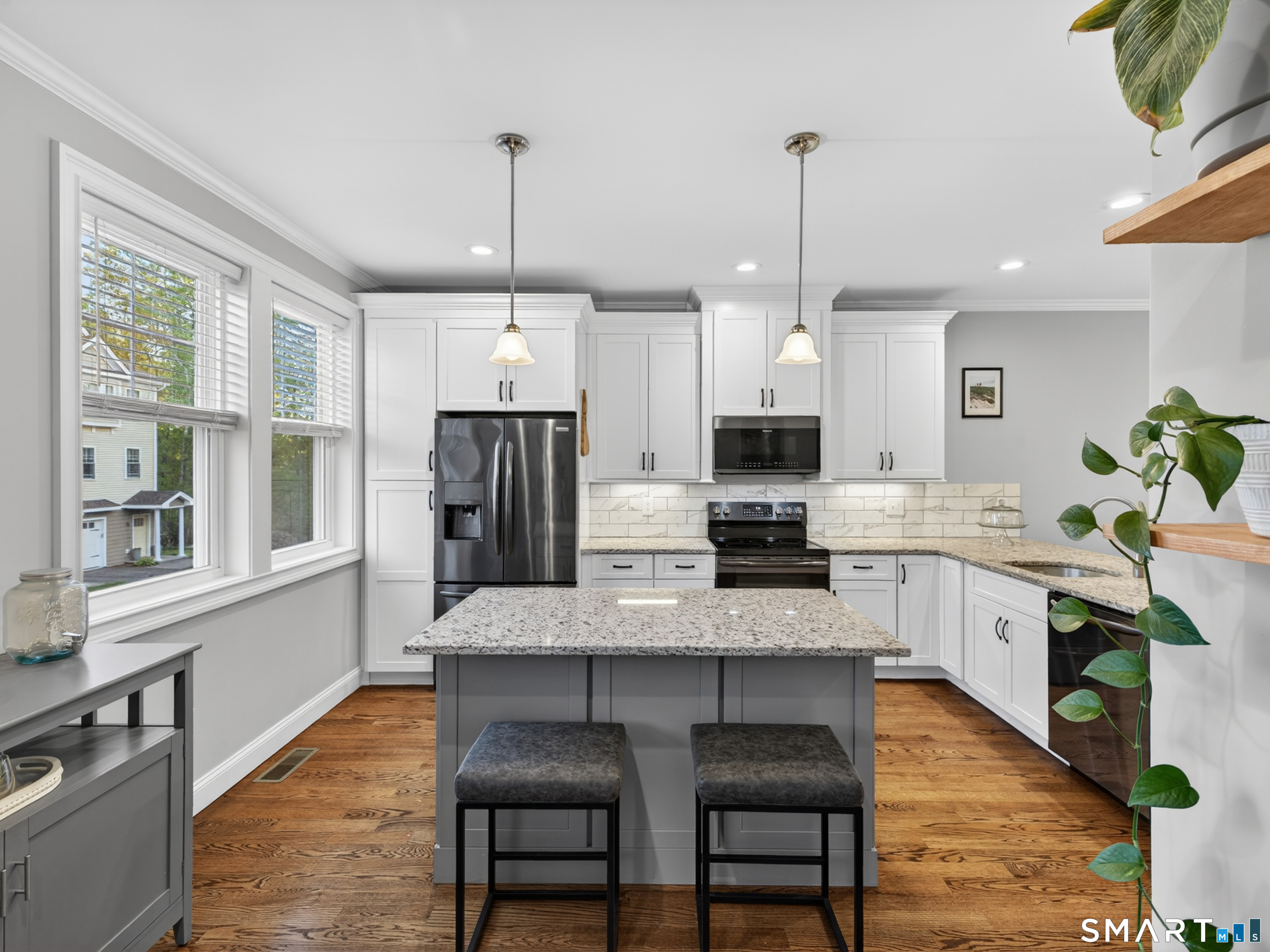 34 Village Crossing, Unit 34 Niantic, CT 06357 - Photo 18 of 38 a kitchen with stainless steel appliances granite countertop a kitchen island hardwood floor sink stove and granite counter top