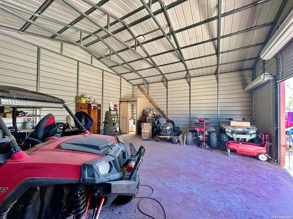 a view of a garage with a bike and a car