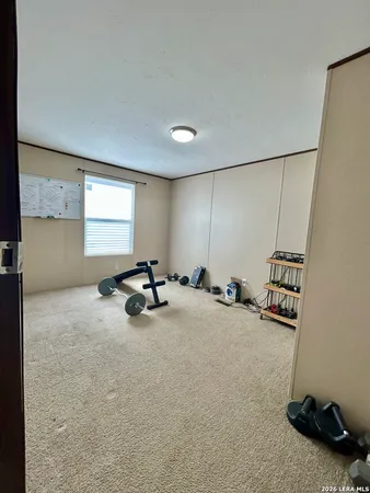 a view of a room with gym equipment and a window