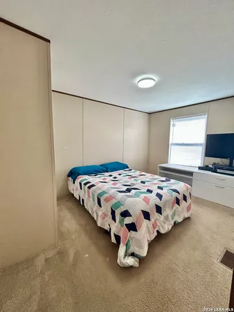 a bedroom with a bed and window