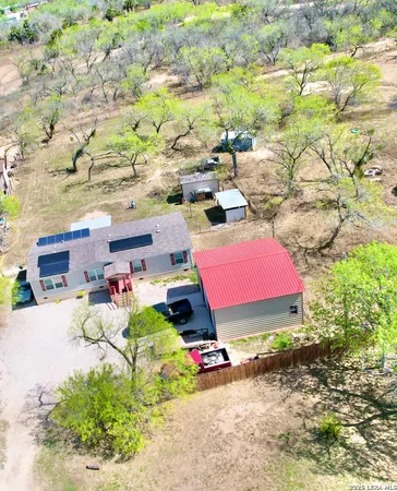 a view of backyard with a table and chairs
