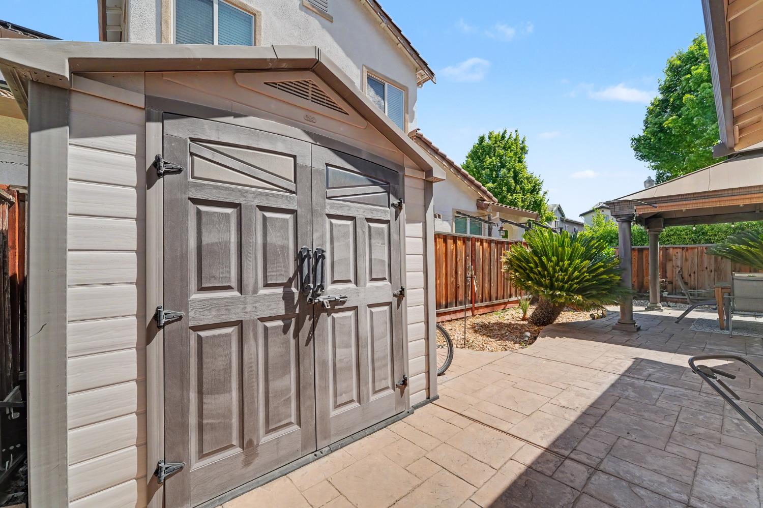 1223 East Springer Drive Turlock, CA 95382 - Photo 47 of 48 a view of a wooden door with a bench