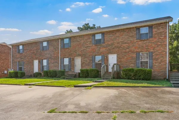 a view of a brick building next to a yard