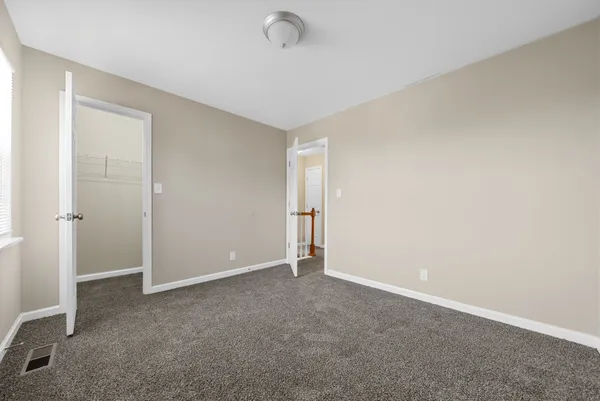 an empty room with closet area