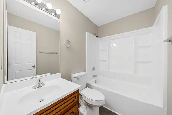 a bathroom with a sink toilet tub and shower