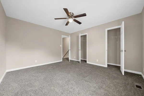 a view of an empty room with a ceiling fan