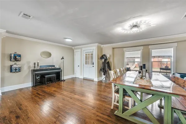 a view of a dining room with furniture and wooden floor