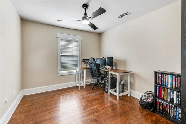 a view of a workspace with furniture and wooden floor