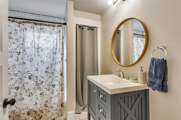 a large bedroom with a bed and flat screen tv