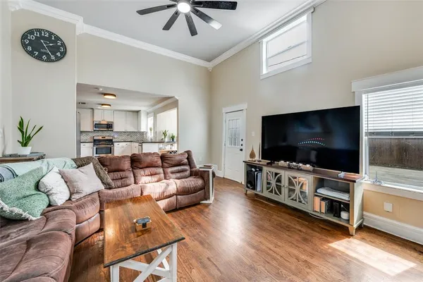 a living room with furniture and a wooden floor