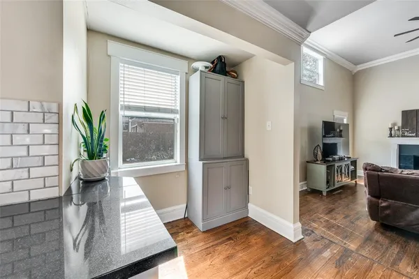 a living room with furniture and kitchen view