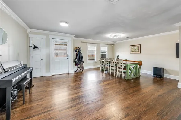 a view of a dining room with furniture window and wooden floor