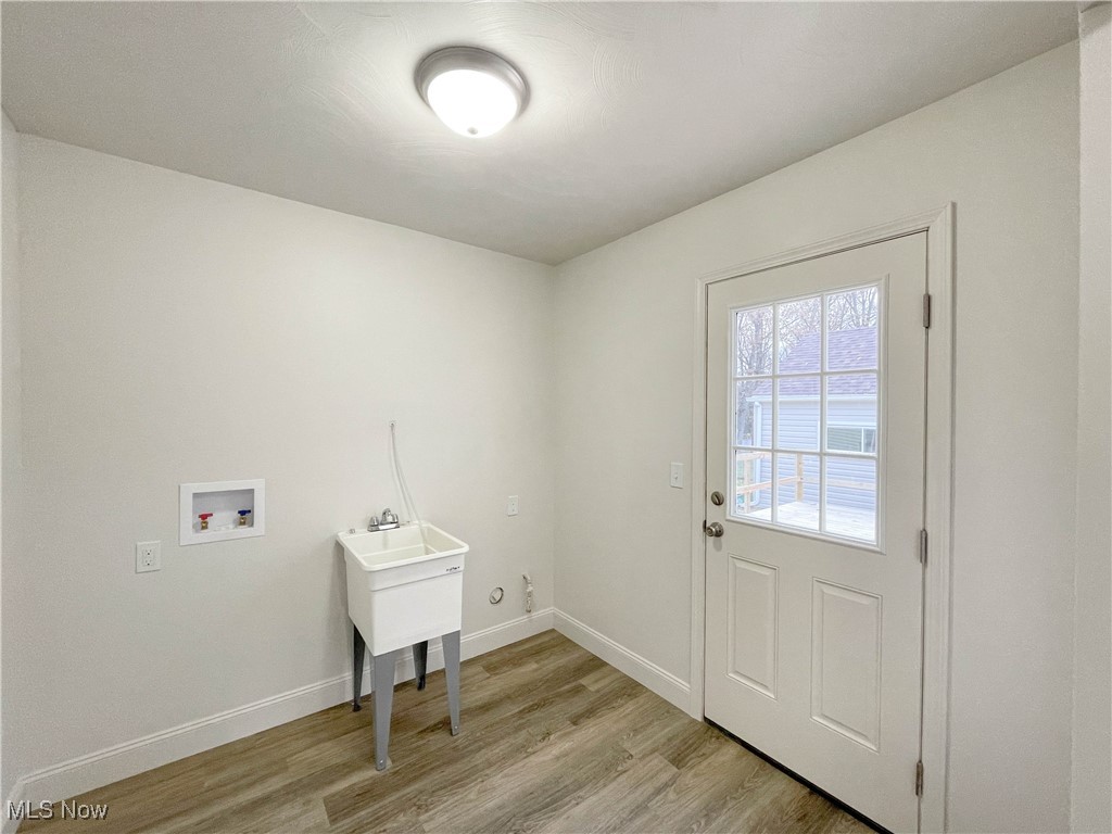 4949 East Radio Road Youngstown, OH 44515 - Photo 26 of 37 Clothes washing area featuring washer hookup and light hardwood / wood-style flooring
