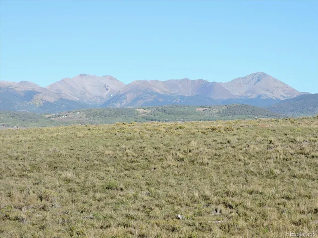 a view of an ocean with mountains in the background