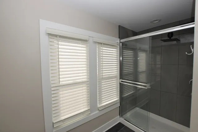 a bathroom with a shower and a sink