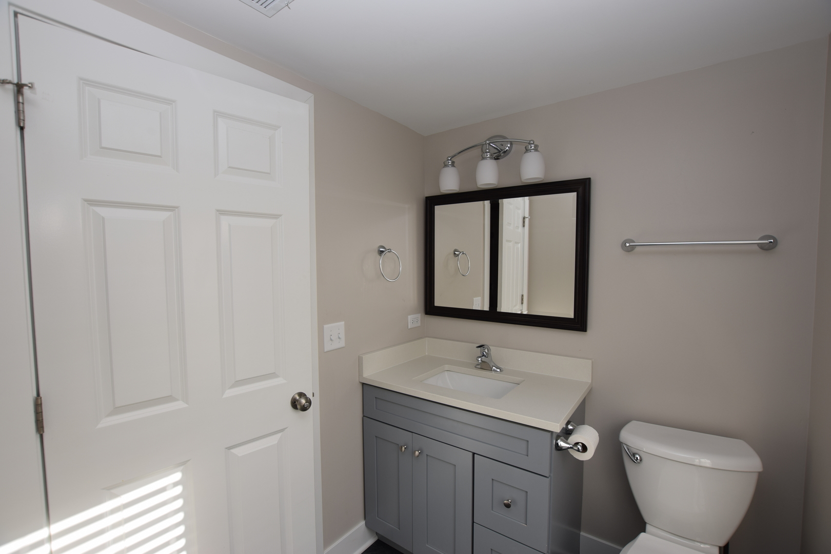 412 Lincoln Avenue, Unit B Fox River Grove, IL 60021 - Photo 15 of 16 a bathroom with a sink toilet and mirror
