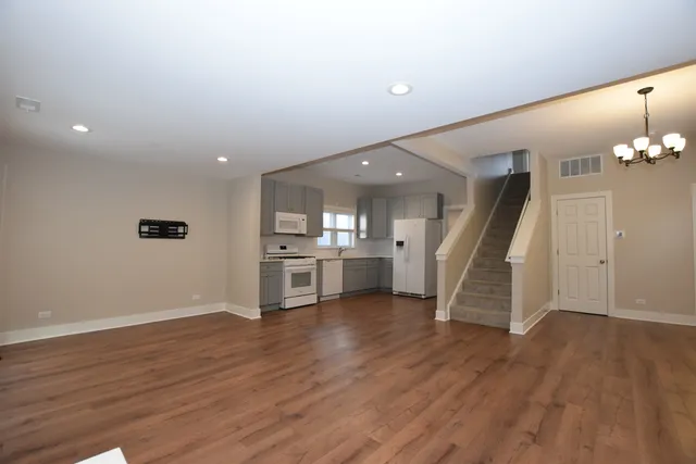 a view of a room with wooden floor and stairs