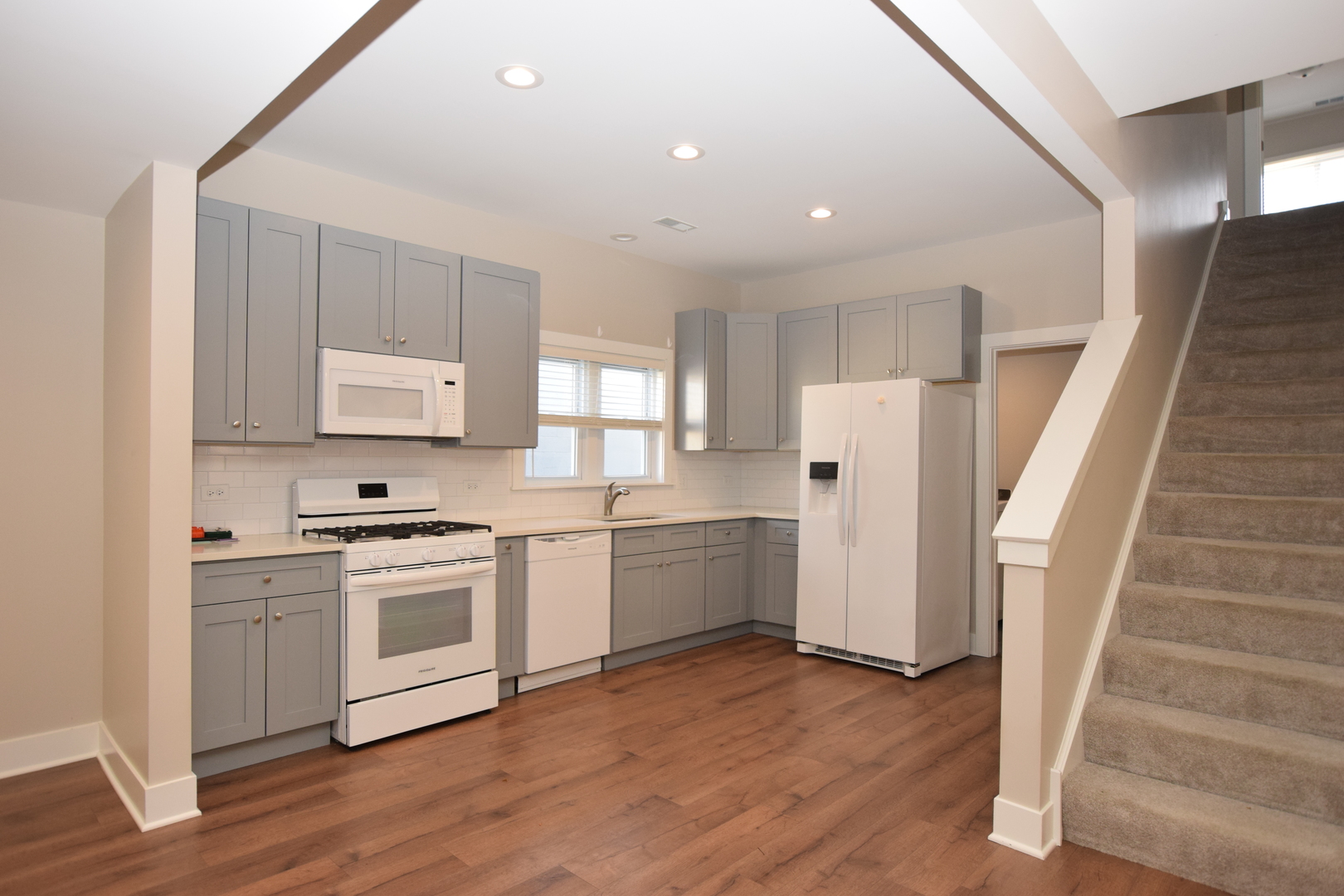 412 Lincoln Avenue, Unit B Fox River Grove, IL 60021 - Photo 4 of 16 a kitchen with white cabinets and white appliances