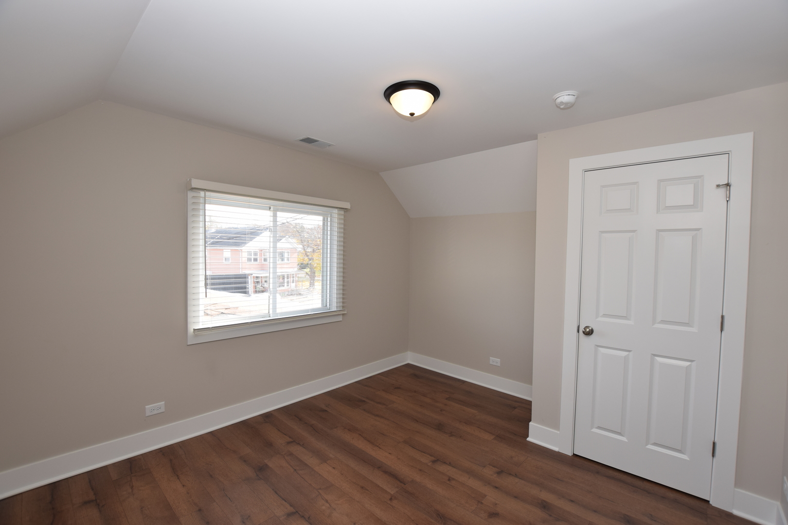 412 Lincoln Avenue, Unit B Fox River Grove, IL 60021 - Photo 10 of 16 an empty room with wooden floor and windows