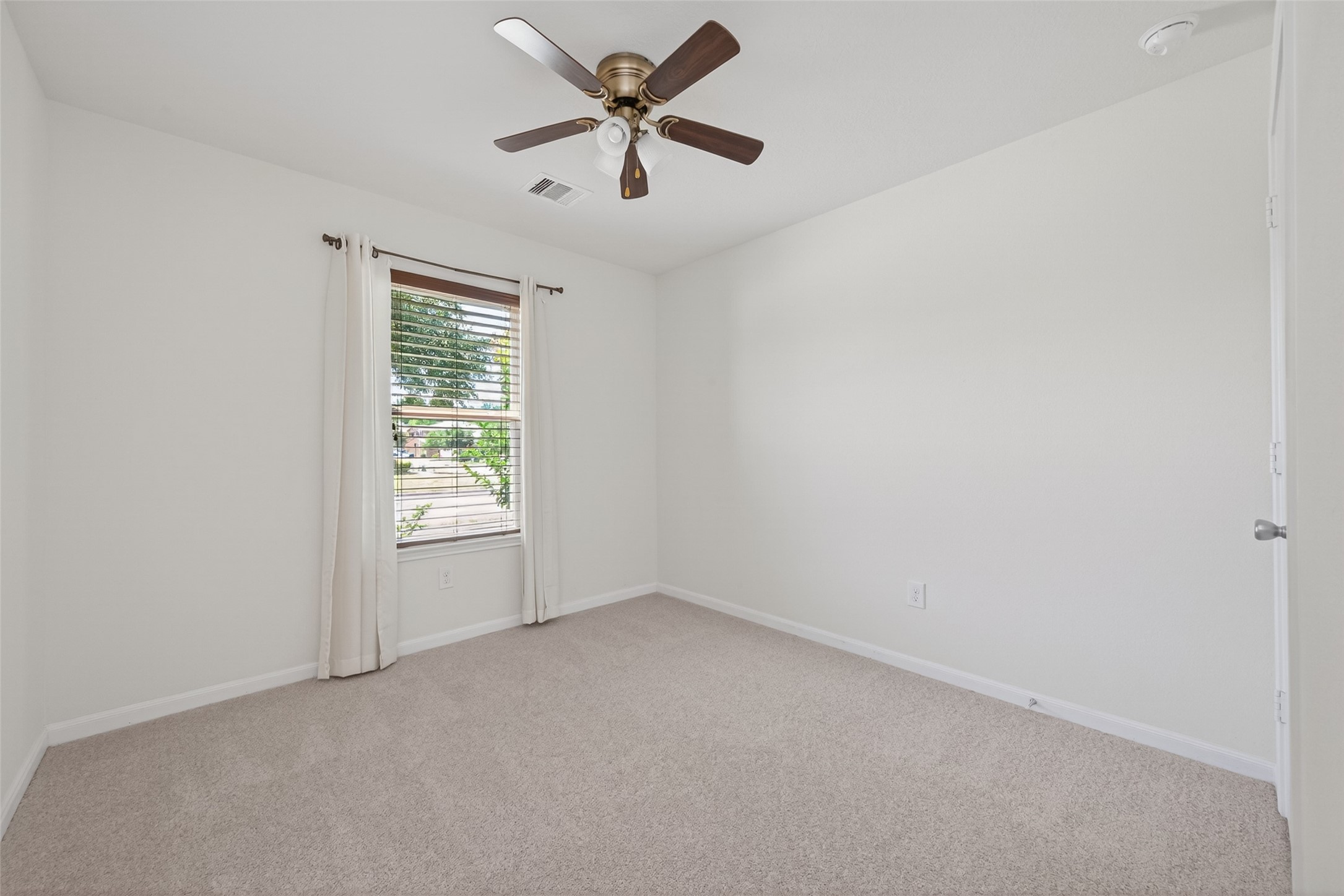 2754 Cayden Creek Way Conroe, TX 77304 - Photo 21 of 40 an empty room with a window and a fan